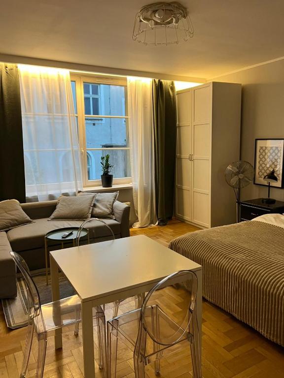 a living room with a bed and a couch at Main Square Sławkowska Apartment in Krakow
