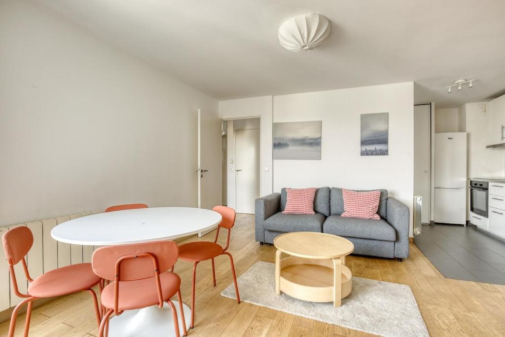 a living room with a table and chairs and a couch at Le Palacio in Saint-Denis