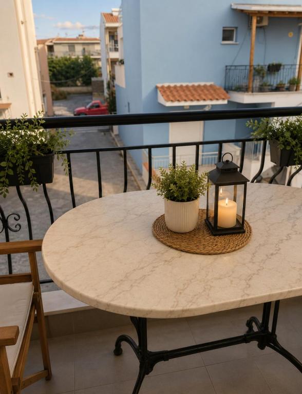 a table with a candle on a balcony at Dinas house ofrinio in Ofrínion