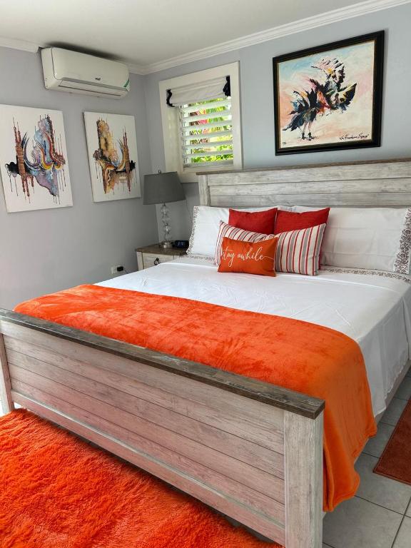 a bedroom with a large bed with an orange blanket at Millsborough B&B in Billy Dun
