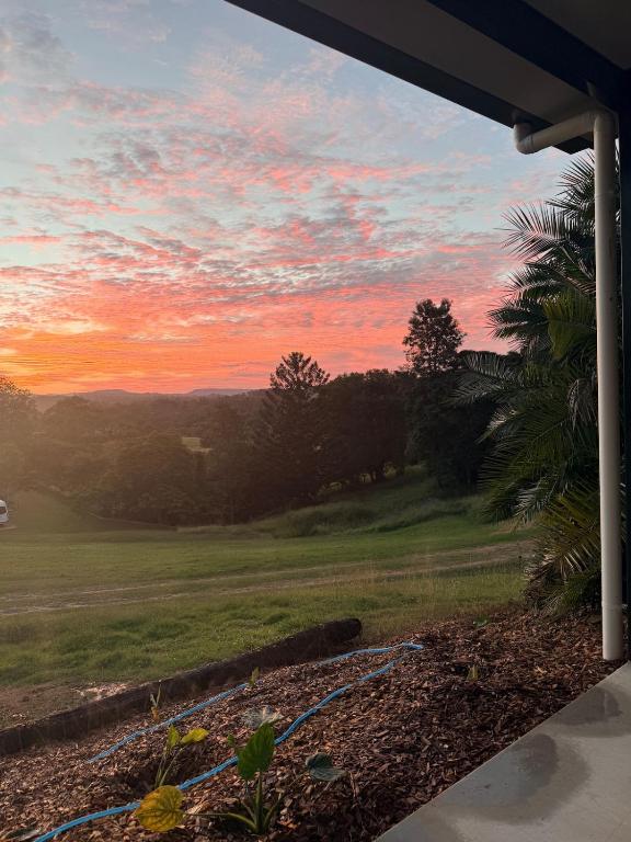 a sunset over a golf course with a hose at Valley View House in Gympie
