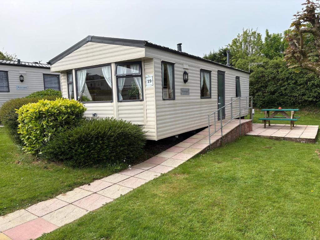 a white house with a picnic table in a yard at 19 Vale Park in Fishguard