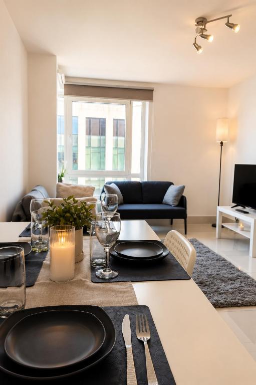 a dining room table with plates and glasses on it at Modern Bright Flat Central & Stylish in Central Station