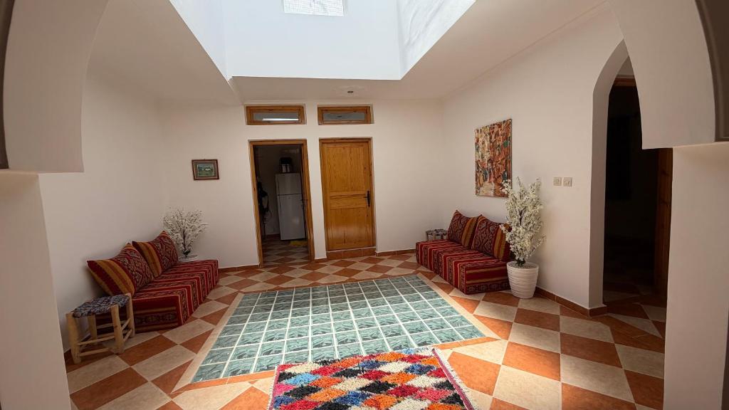 a living room with two couches and a rug at Peaceful Retreat in Oulad Akkou