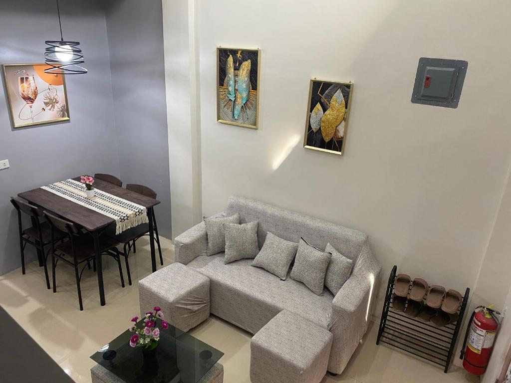 a living room with a couch and a table at ZK Loft Staycation Gensan in General Santos