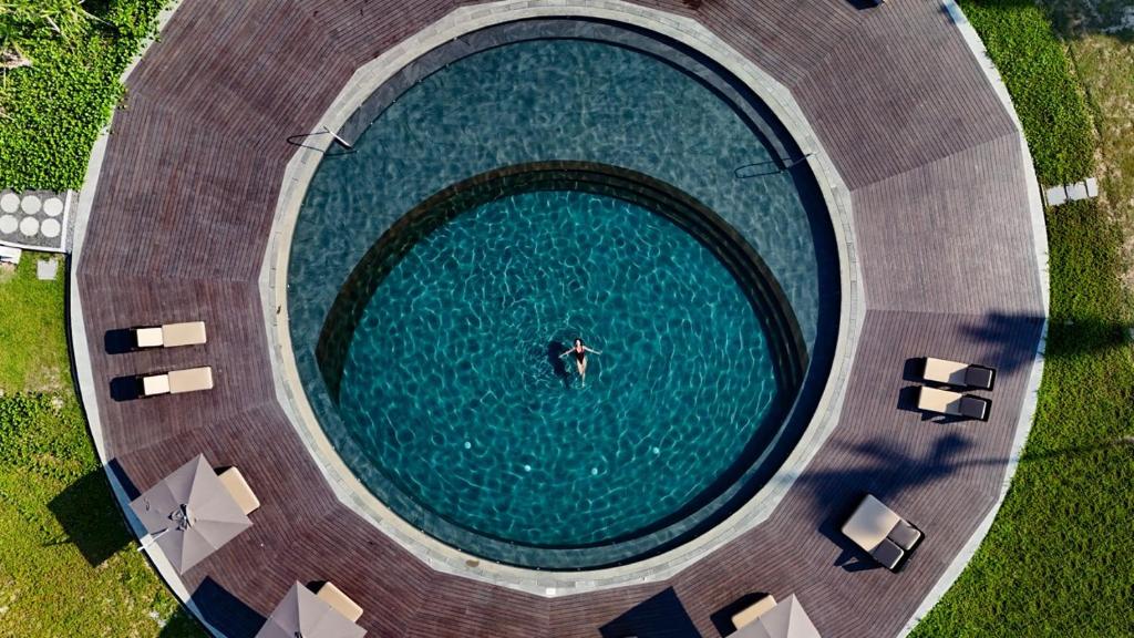 an overhead view of a swimming pool with a person in the water at Amorita Resort Palawan in Puerto Princesa