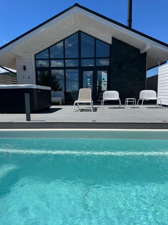 a group of chairs sitting next to a swimming pool at be be Chalet mini - privat pool & jacuzi in Bukovel