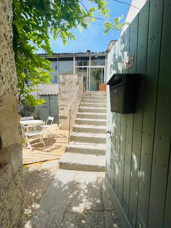a set of stairs leading up to a building at Aube du Tilleul in Lagorce