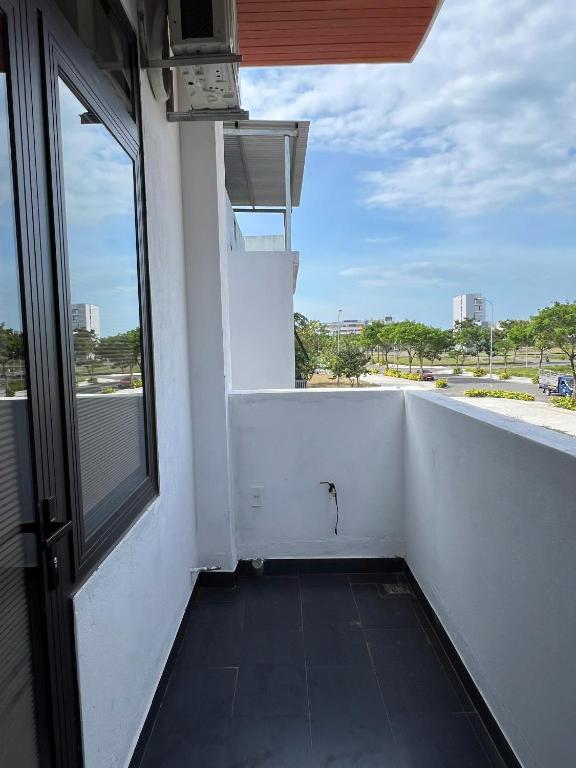 a balcony with a window and a view of a street at The F House in Danang