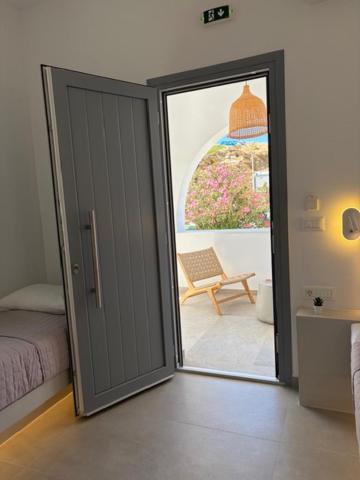 an open door to a bedroom with a bed and a patio at The Dream in Ios Chora