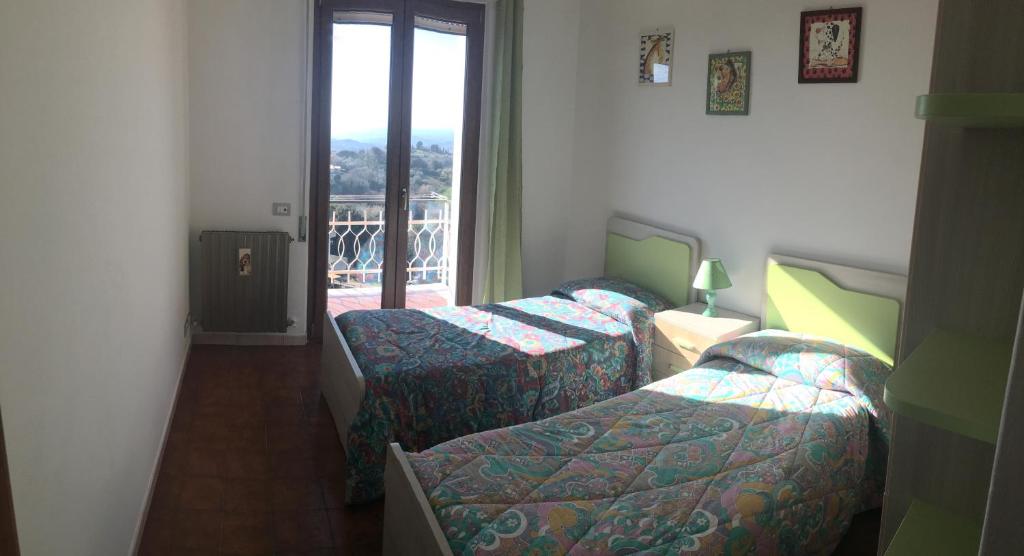 a hotel room with two beds and a window at Casa Vacanze Elisa in Manciano