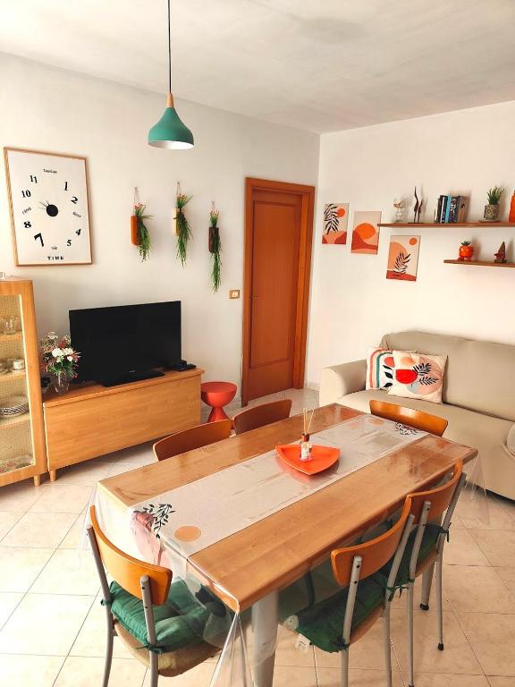 a living room with a wooden table and chairs at Golden Hour House in Termoli