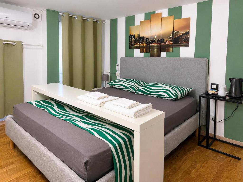 a bedroom with a bed with a desk on it at Milano Brenta Suites Room for 2 in Milan