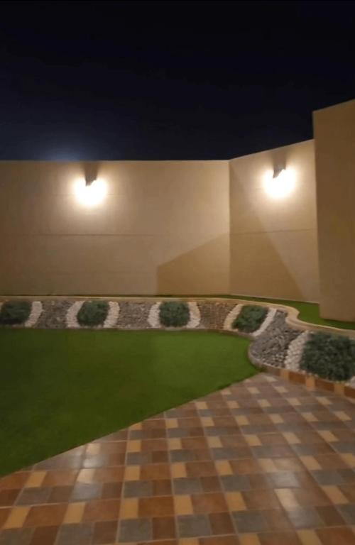 a rendering of a room with a lawn and lights at Ezdan Residence إزدان رزيدينس in Unayzah