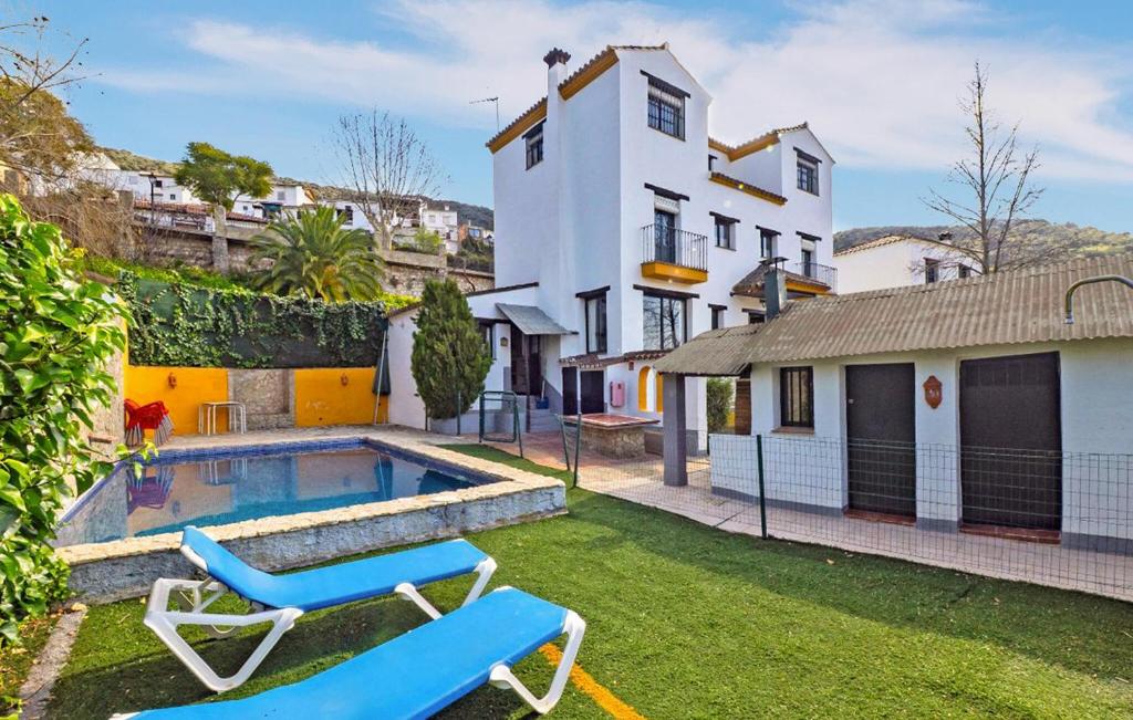 a house with a swimming pool and two lounge chairs at Casa Rural La Albahaca in Jimera de Líbar