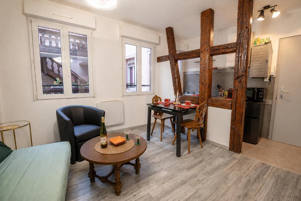 a living room with a table and a kitchen at Cocon alsacien Sélestat Centre historique in Sélestat