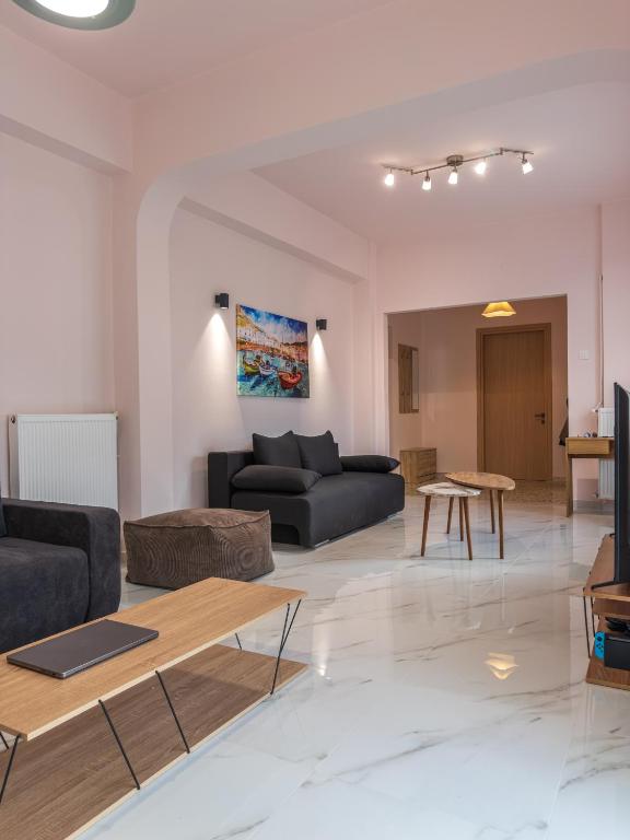 a living room with a couch and a table at Morpheas Apartment in Central Myrina in Myrina