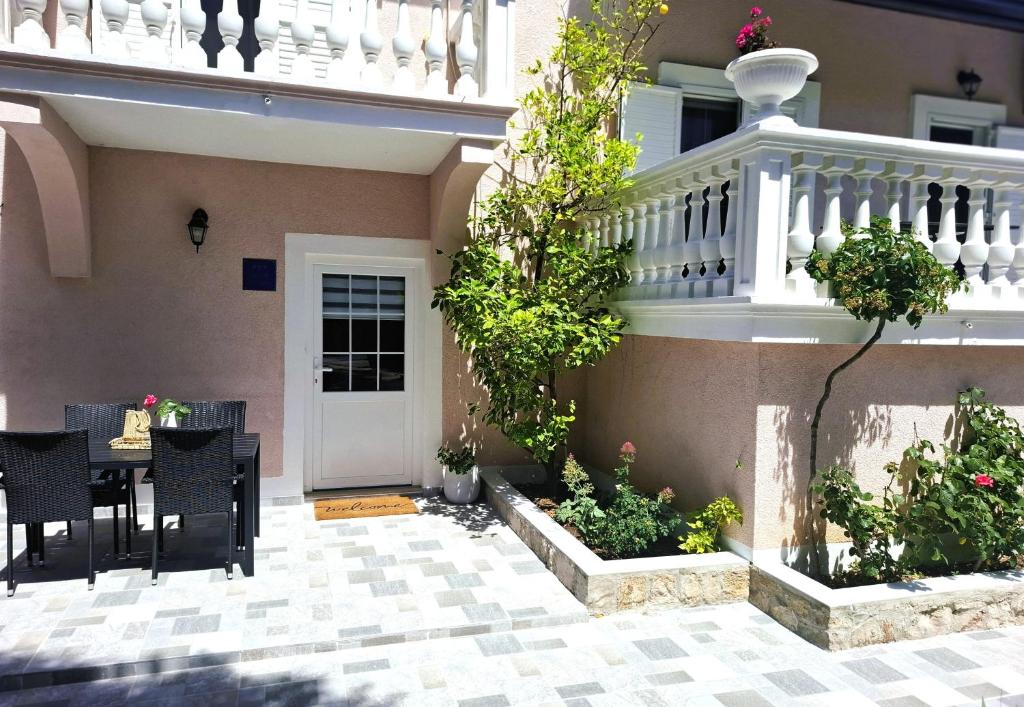 a patio with a table and chairs in front of a house at Vecky in Jezera