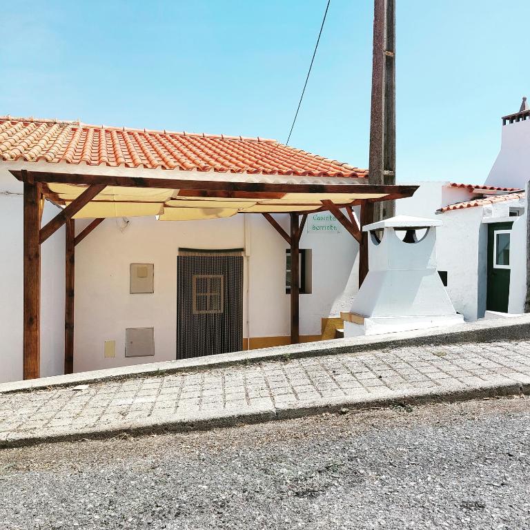 a building with awning on the side of a street at Casinha Serrinha in Mértola