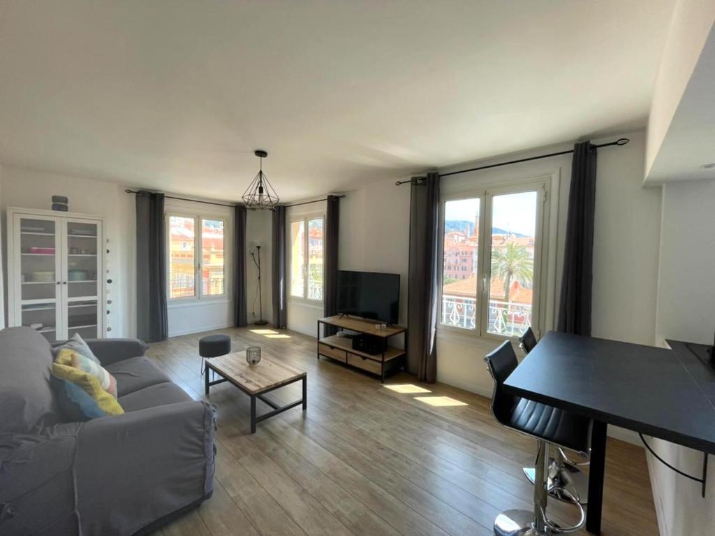 a living room with a couch and a piano at VERLAINE House in Menton