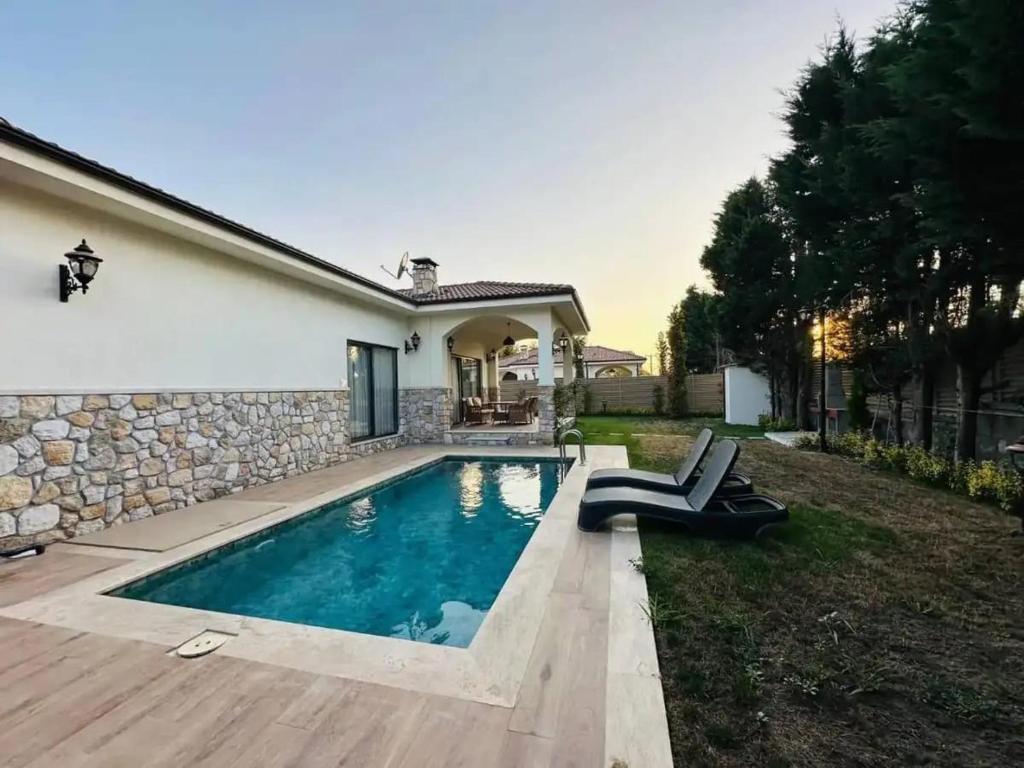 a swimming pool in the backyard of a house at Eco villa in Quba