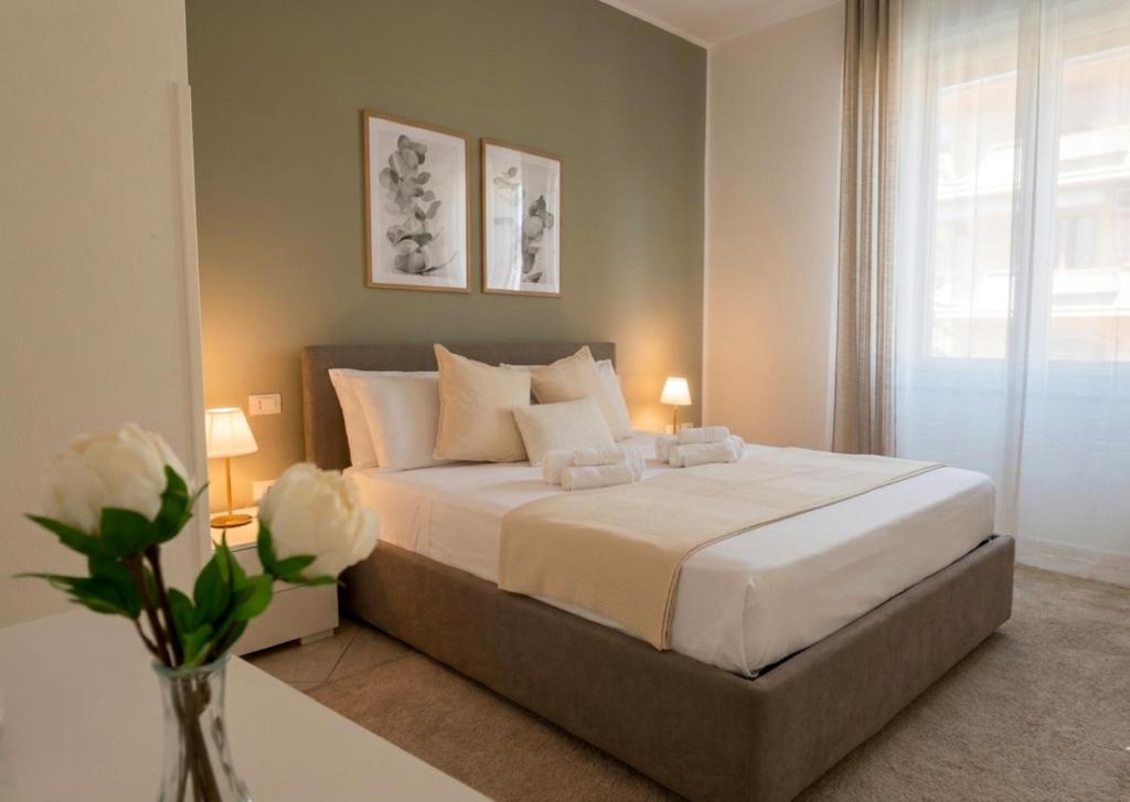a bedroom with a large white bed with two lamps at Deluxe Flat Empoli GVARO in Empoli