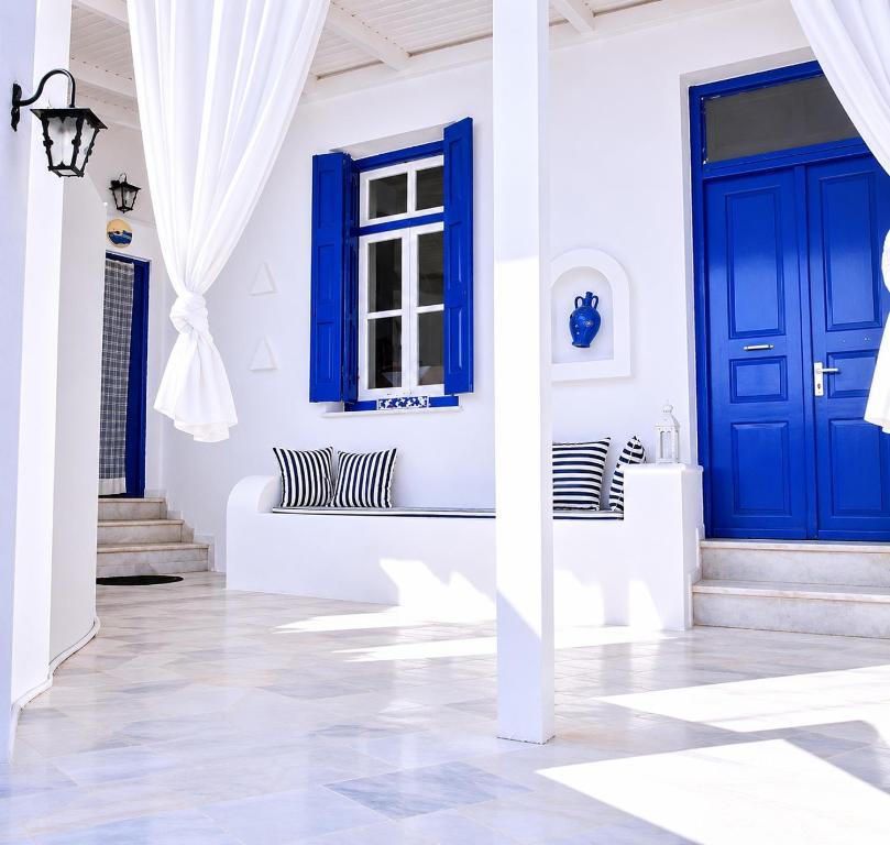 a house with blue doors and white walls at Lemonia House in Vívlos