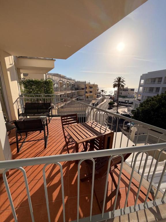 a balcony with a table and chairs on a building at relax by the sea in Puerto de Santiago