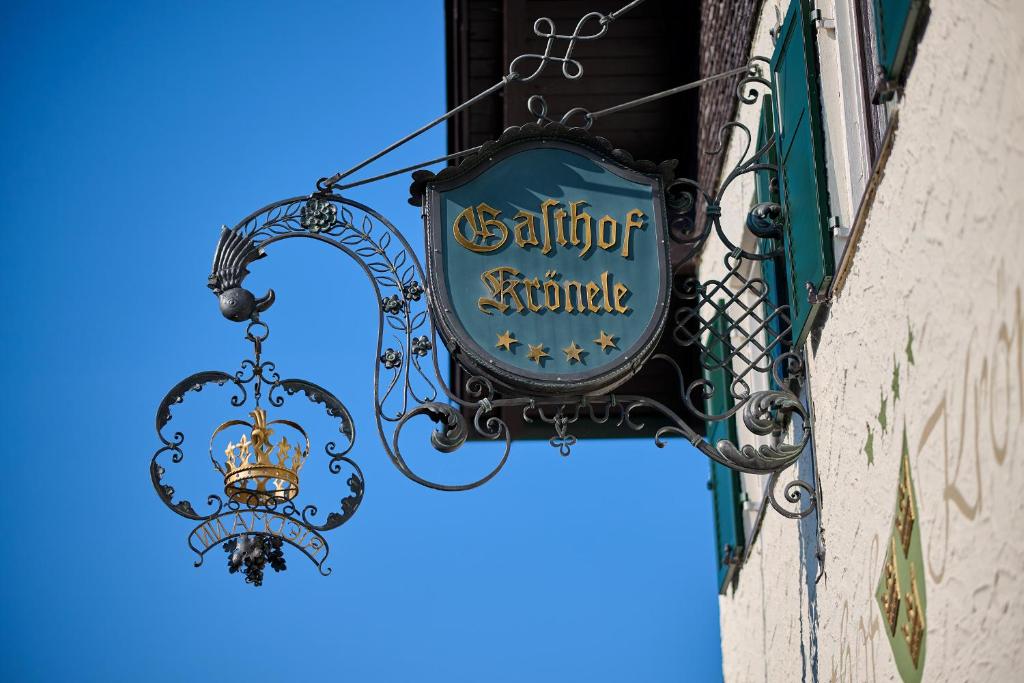 a sign for a restaurant on the side of a building at Hotel Gasthof Krönele in Lustenau