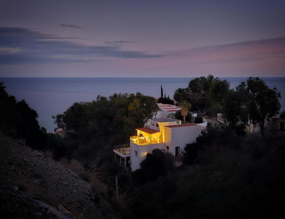 a house with lights on top of it at night at El Nido in Mojácar
