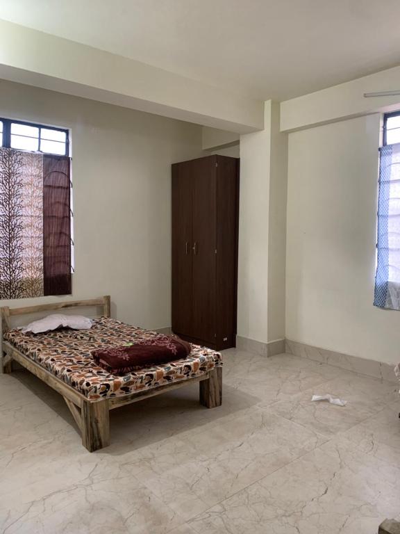 a bedroom with a bed in the corner of a room at The 1802 travellers inn in Shillong