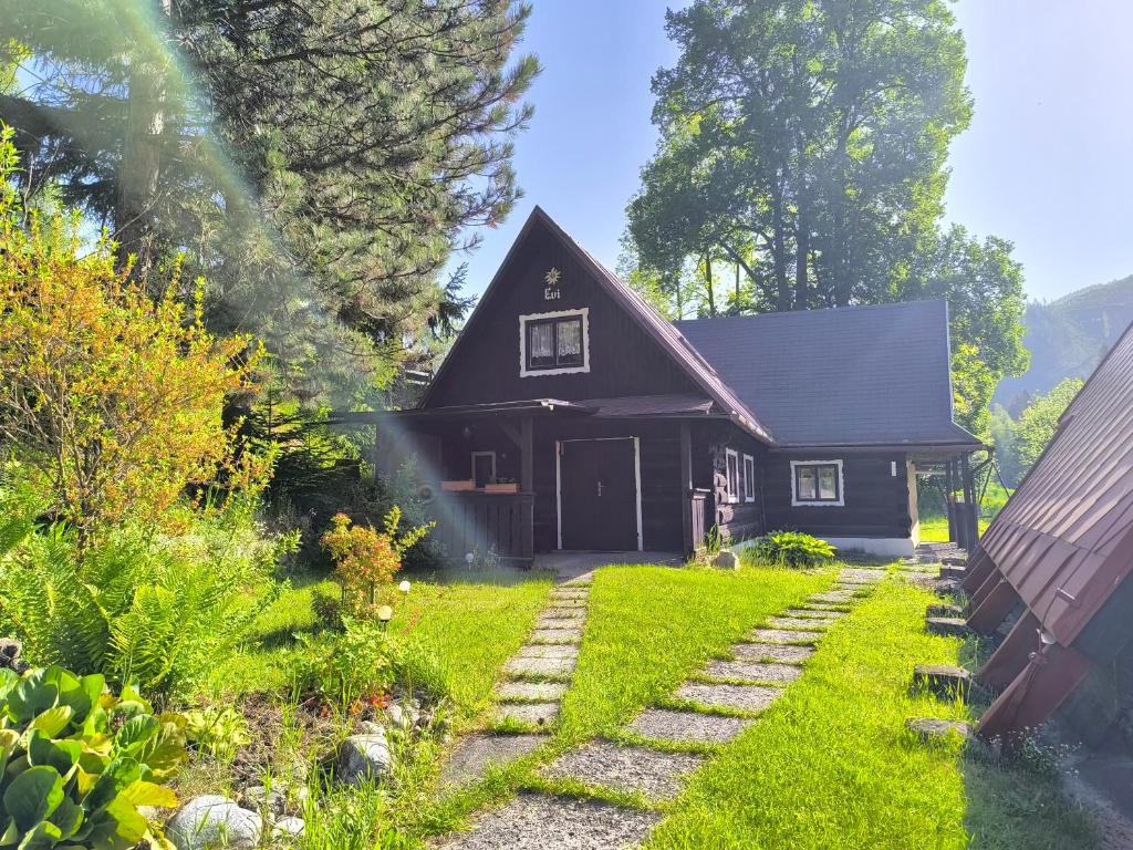 a house with a garden in front of it at Privát Evi 166 in Nižná Boca