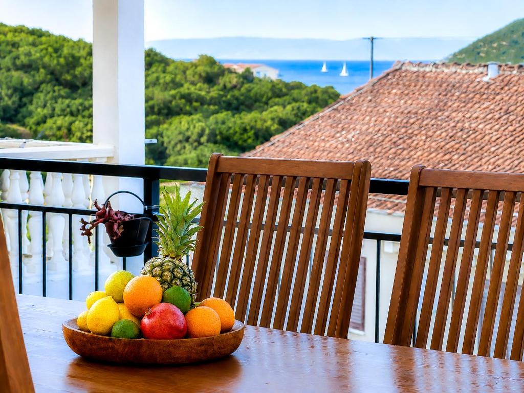 a bowl of fruit on a table on a balcony at Apartment Stella in Vis
