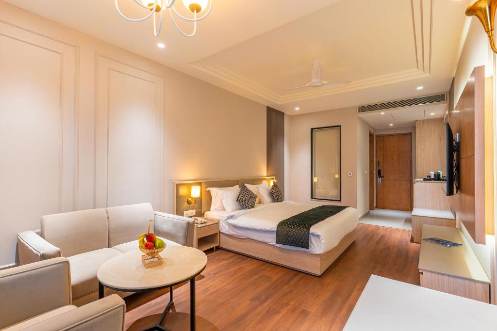 a hotel room with a bed and a living room at Ranveer The Garden Resort in Haldwāni
