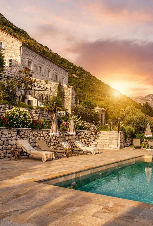 a villa with a swimming pool and a building at Casa Vita Nova in Perast