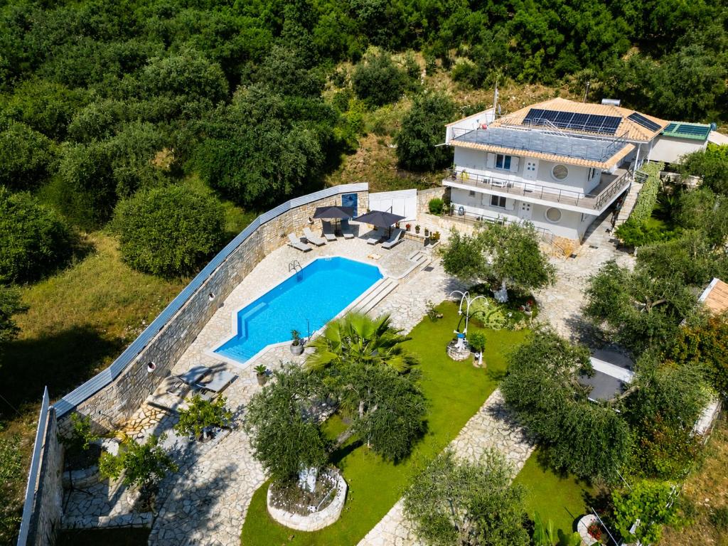 an aerial view of a house with a swimming pool at La Sirenetta Residence in Syvota