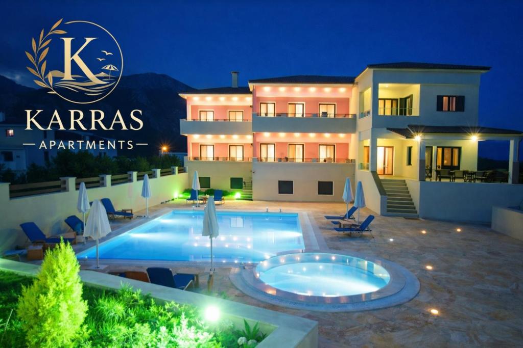 a villa with a swimming pool at night at Karras Apartments in Gliki