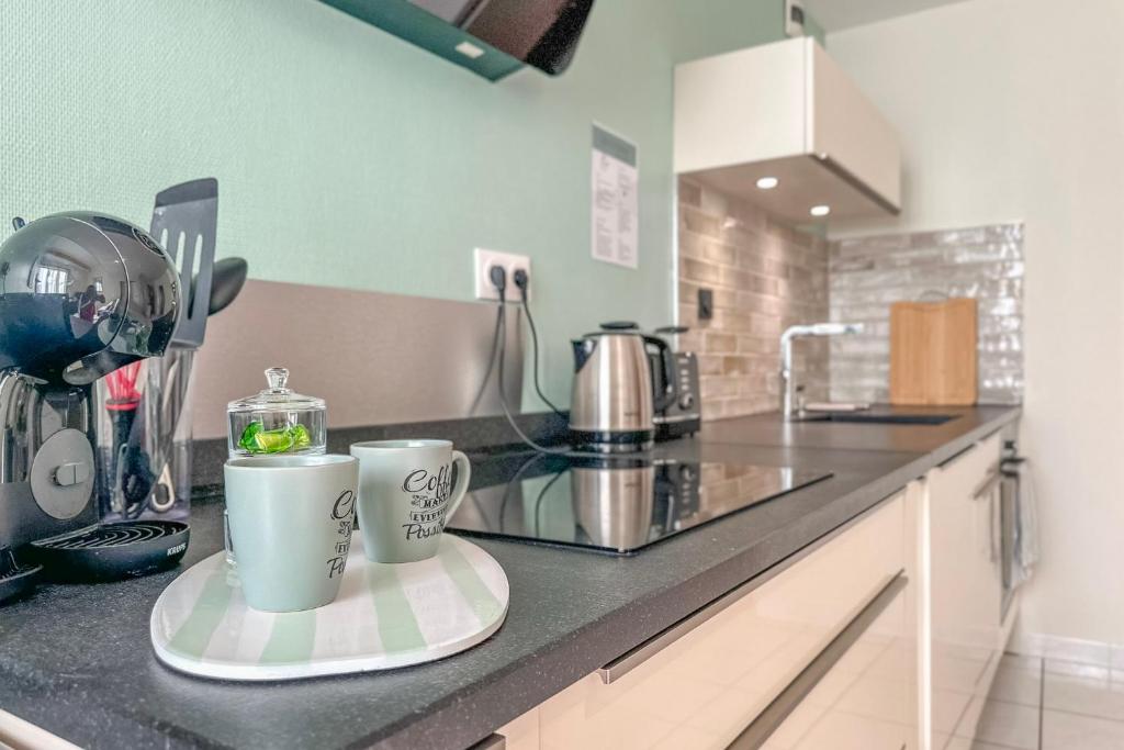 a kitchen counter with two coffee mugs on it at Cocon en Chartreuse in Voreppe