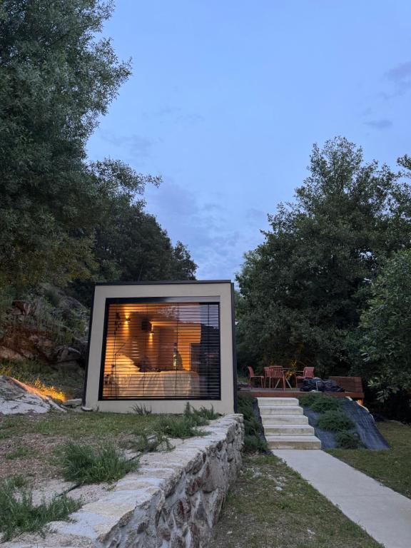 a fireplace in the middle of a yard at Riverside Lodges - Serra da Estrela - Chão da Ribeira in Gouveia