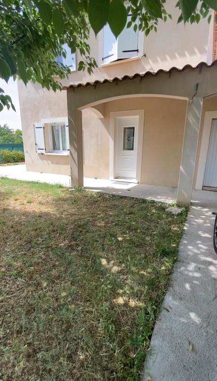 a house with a garage in front of it at Le clos des voies in Ganges