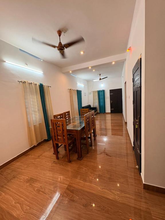 a dining room with a table and chairs at Baylio Homestay in Kappil