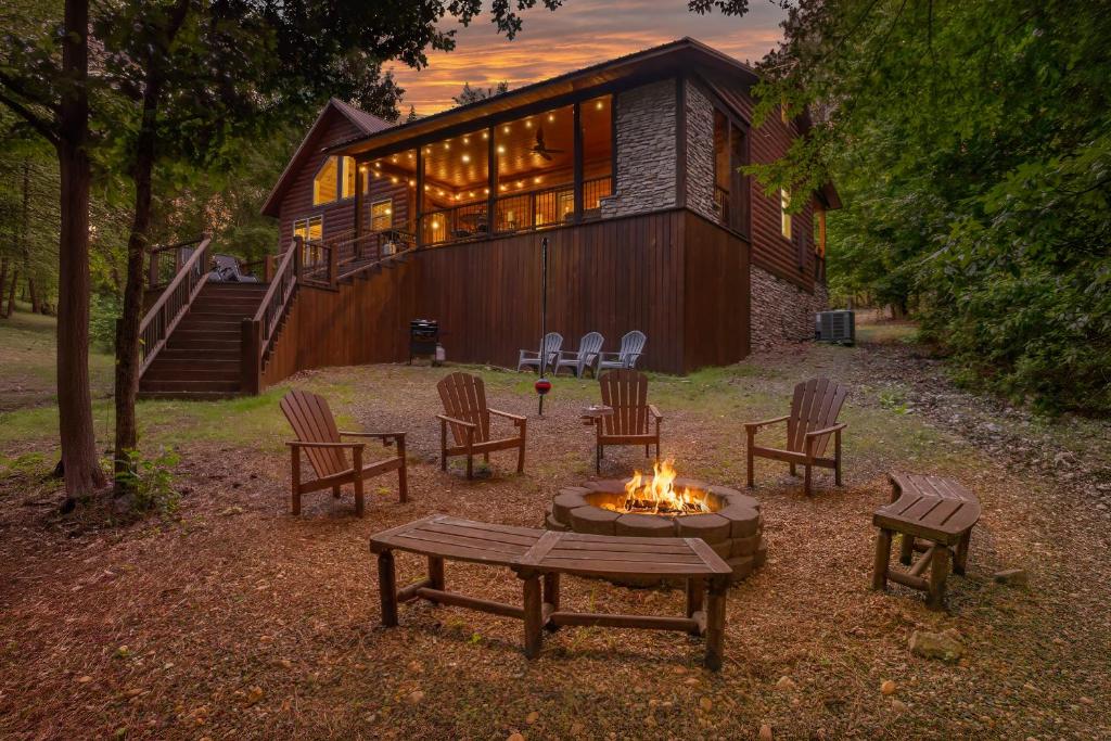 a fire pit in front of a house at Twilight Pines - Dreamy Cabin w Hot Tub & optional Kids Loft in Broken Bow