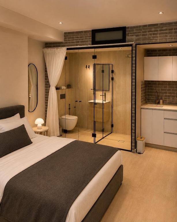 a bedroom with a bed and a bathroom with a tub at Dizengoff Square Garden - by BAR COLLECTION in Tel Aviv