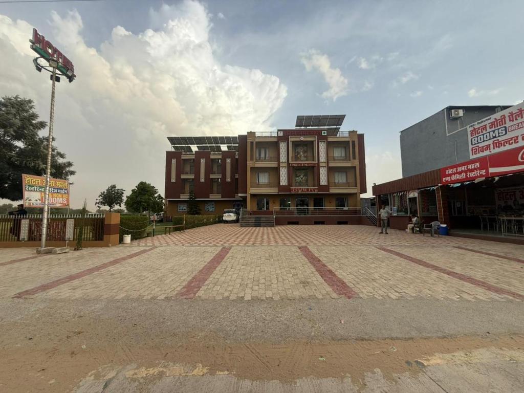 a building on a street in front at Amar mahal hotel and restaurant in Khātu