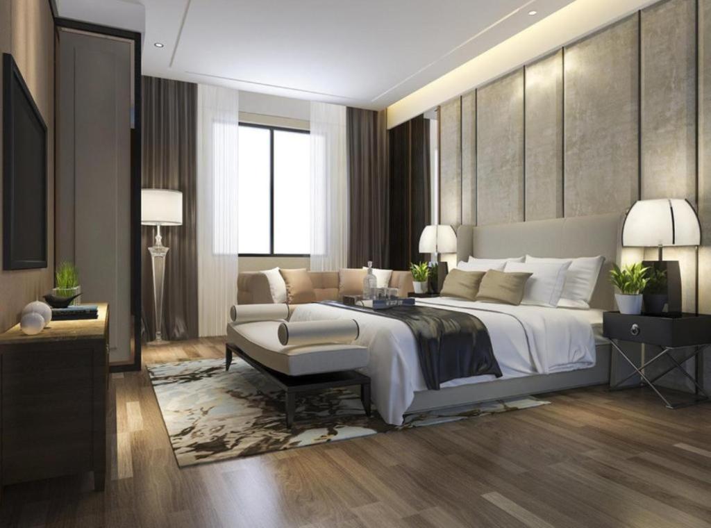 a bedroom with a large white bed and a couch at Hotel Urban ECG Grand - Inn Near IGI Delhi Airport in New Delhi