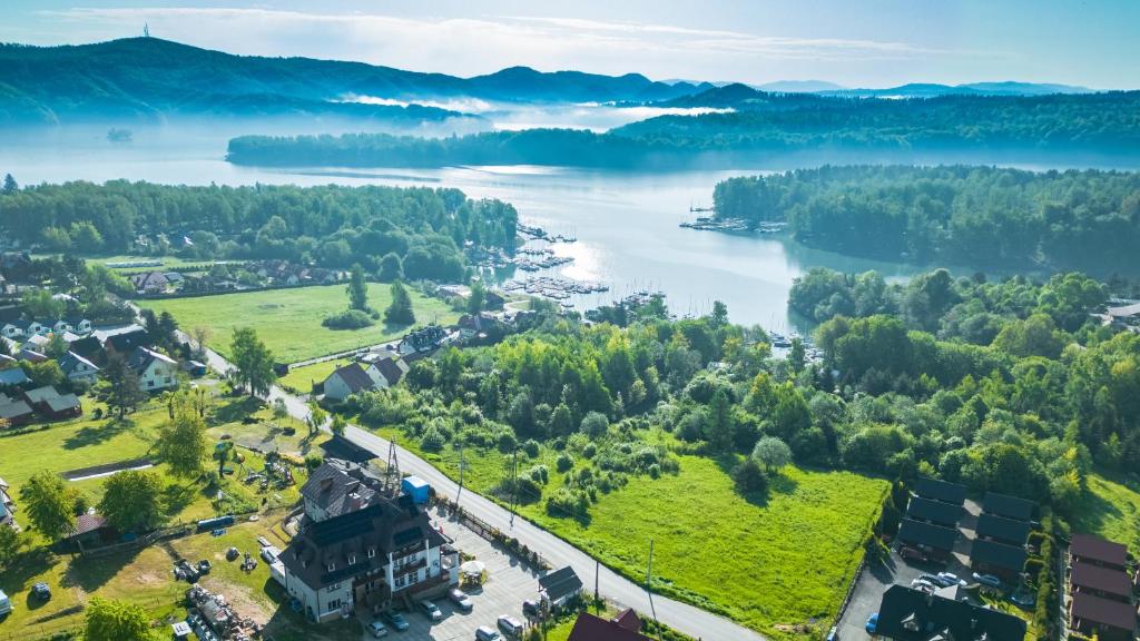 an aerial view of a town and a river at Przystań Caryńska w Polańczyku in Polańczyk