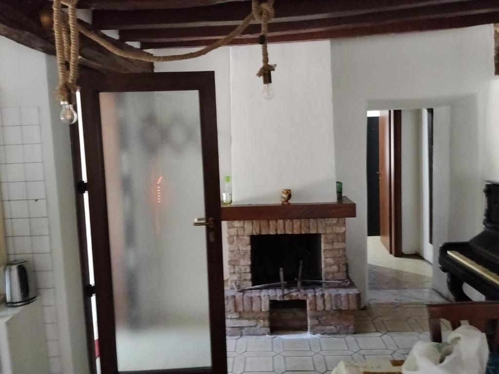 a living room with a fireplace and a mirror at Golden horses in Montebabbio