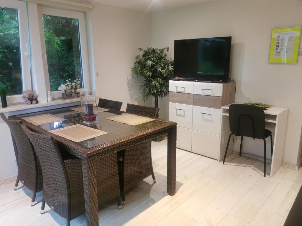 a dining room with a table and a television at Ferienhaus Congolo in Lontzen