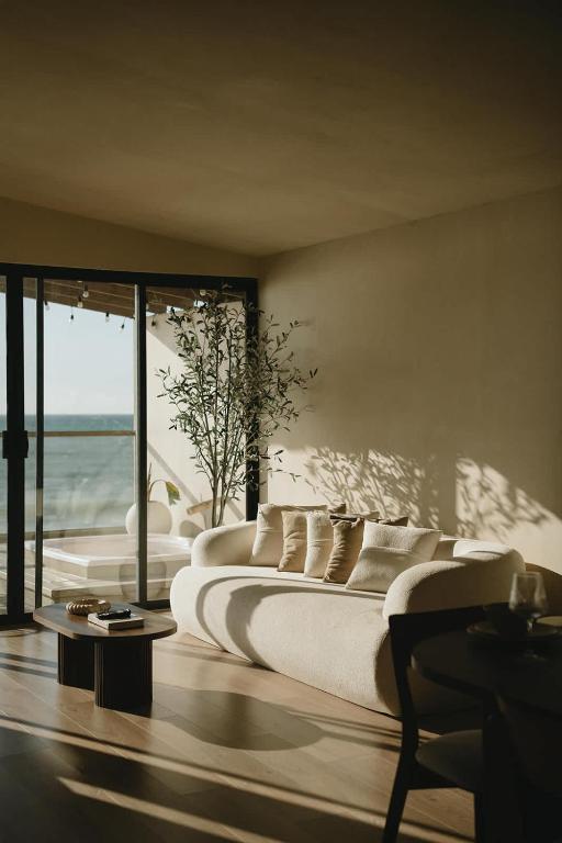 a bedroom with two beds and a view of the ocean at Kasa Dharma an oceanfront House in El Suazal