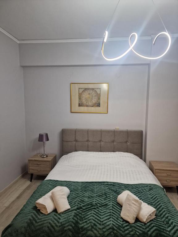 a bedroom with a bed with two pillows on it at Nicolas luxury apartment in Amalias